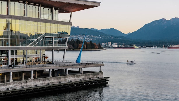 A waterfront building with a modern design, featuring large glass windows and a prominent blue sculpture. - Holiday Inn & Suites Vancouver Downtown by IHG (Vancouver)