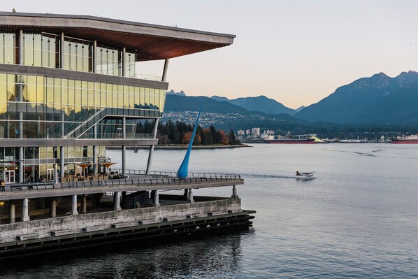 A waterfront building with a modern design, featuring large glass windows and a prominent blue sculpture. - Holiday Inn & Suites Vancouver Downtown by IHG (Vancouver)