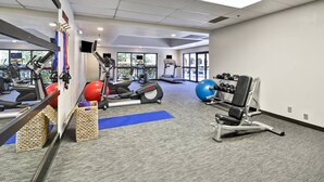 A gym with cardio machines, free weights, and exercise mats. - Fairfield Inn & Suites Dallas Medical/Market Center (Dallas)