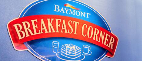 A Baymont Breakfast Corner sign with a red banner and a cake icon.