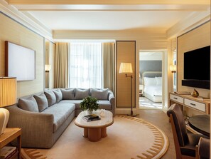 Deluxe Suite | Living area | 55-inch LCD TV with cable channels, TV