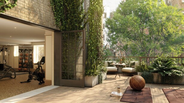 A modern outdoor area with a wooden deck, exercise equipment, a seating area with a table and chairs, and a basketball. - The Surrey A Corinthia Hotel (New York)