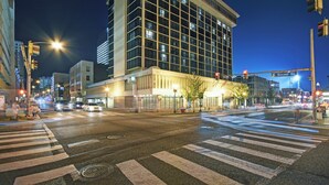 A multi-story building with a modern architectural design, featuring a prominent entrance with a glass facade. - Holiday Inn Downtown Memphis by IHG (Memphis)