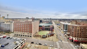 A cityscape with a multi-story parking garage, a large building with a distinctive red and white facade, and a spacious plaza with a colorful mosaic. - Holiday Inn Downtown Memphis by IHG (Memphis)