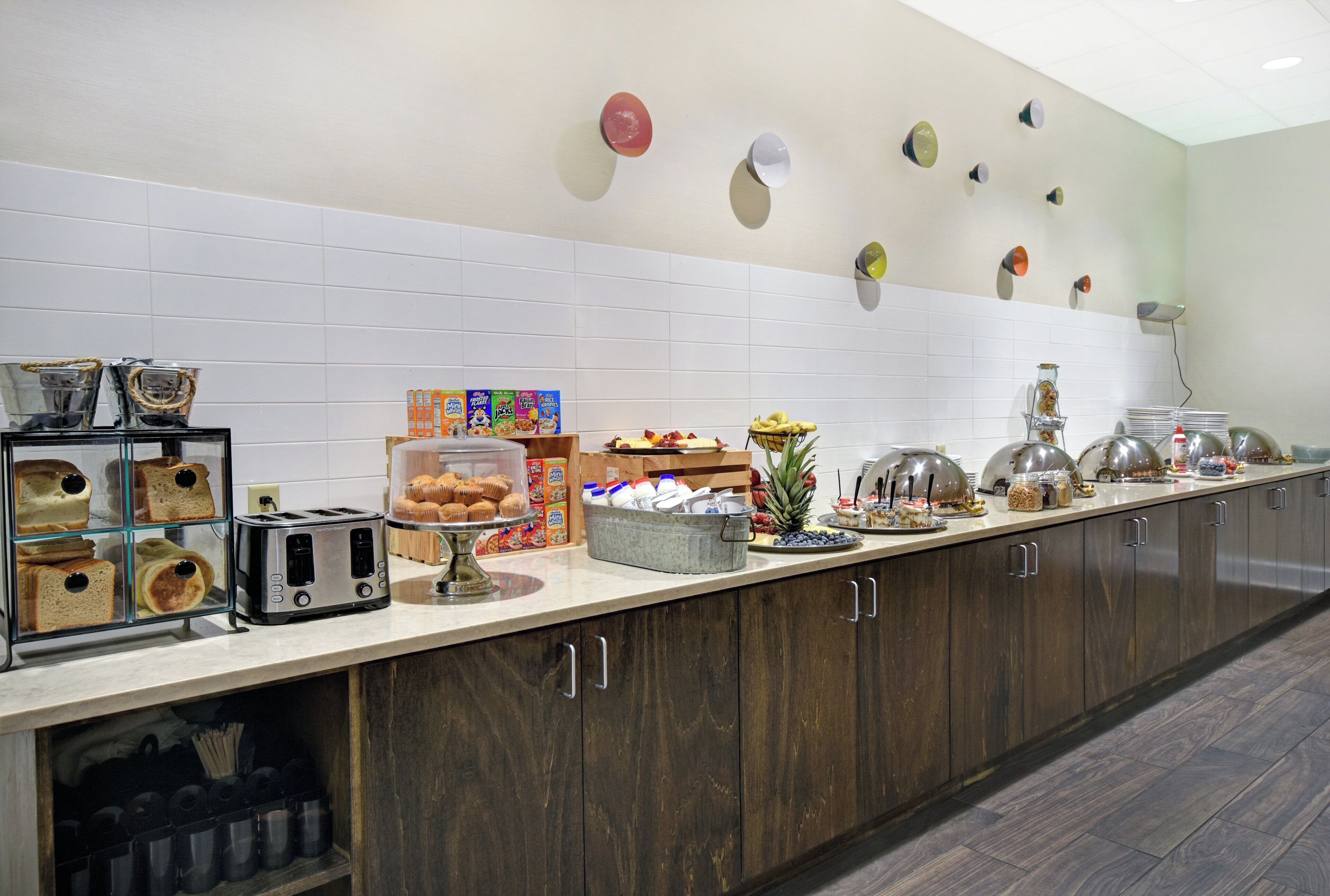 A breakfast bar with various food items and a toaster.