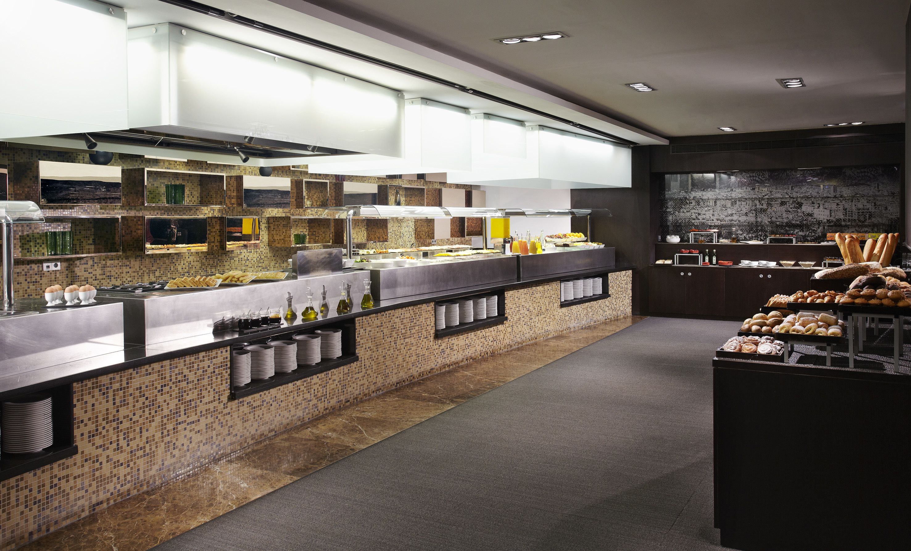A modern breakfast buffet with a variety of food items and beverages.