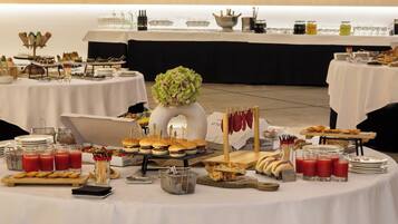 A buffet setup with various food items and beverages.