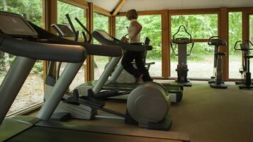 A gym with treadmills, an elliptical, and a stationary bike.