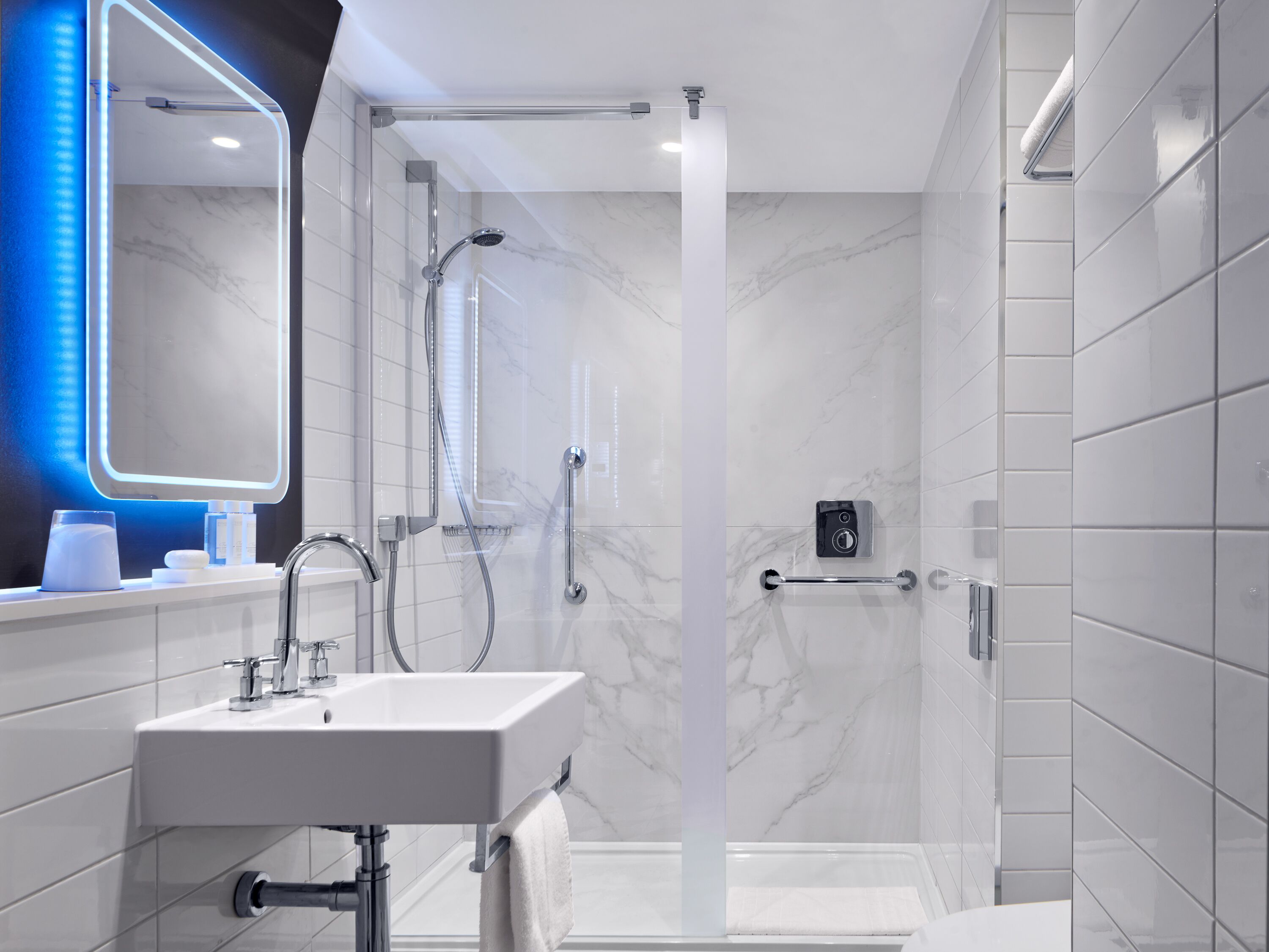 shower, designer toiletries, hair dryer, towels