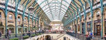 A covered market with a high, arched ceiling and multiple levels.