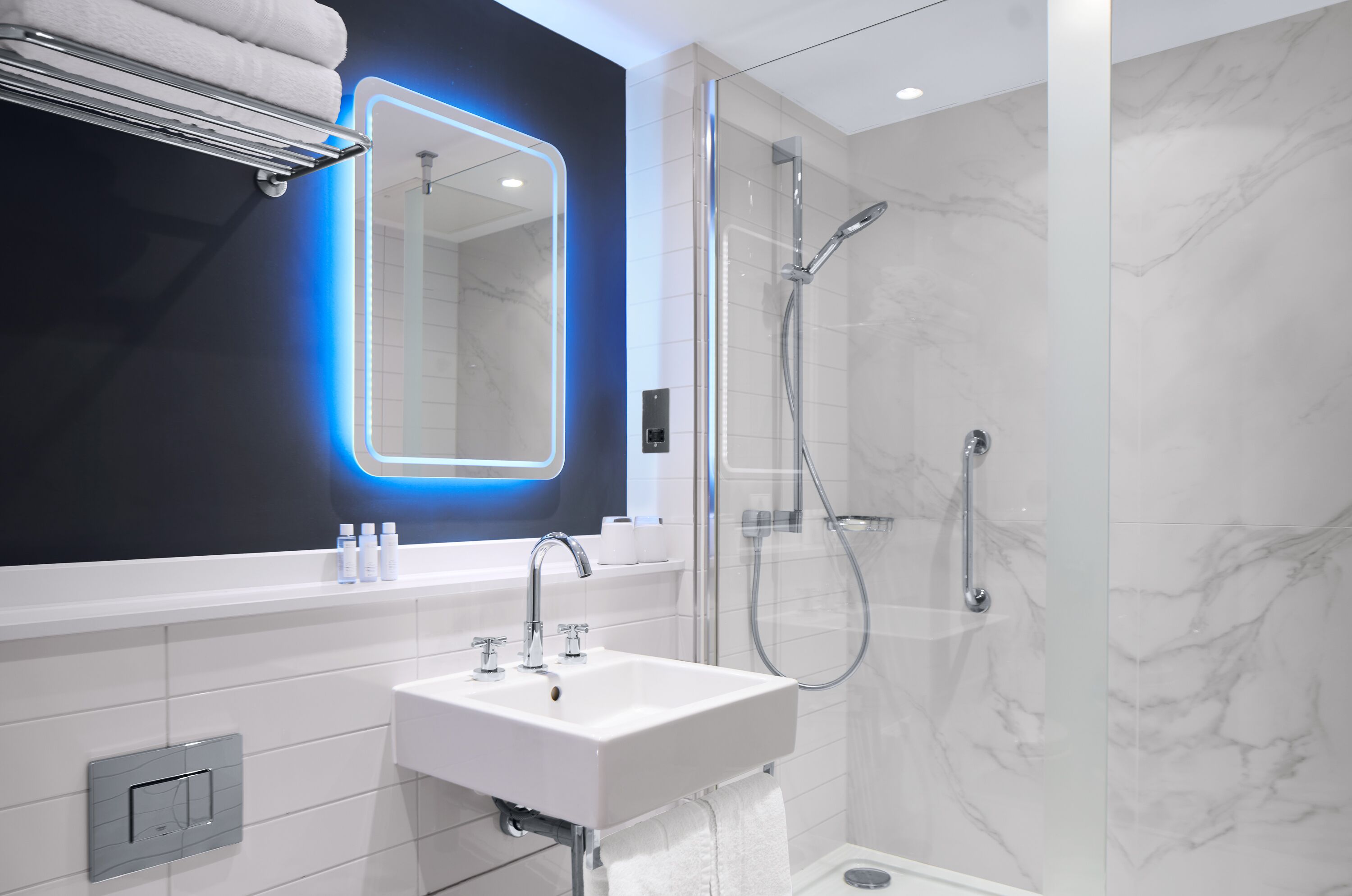 shower, designer toiletries, hair dryer, towels