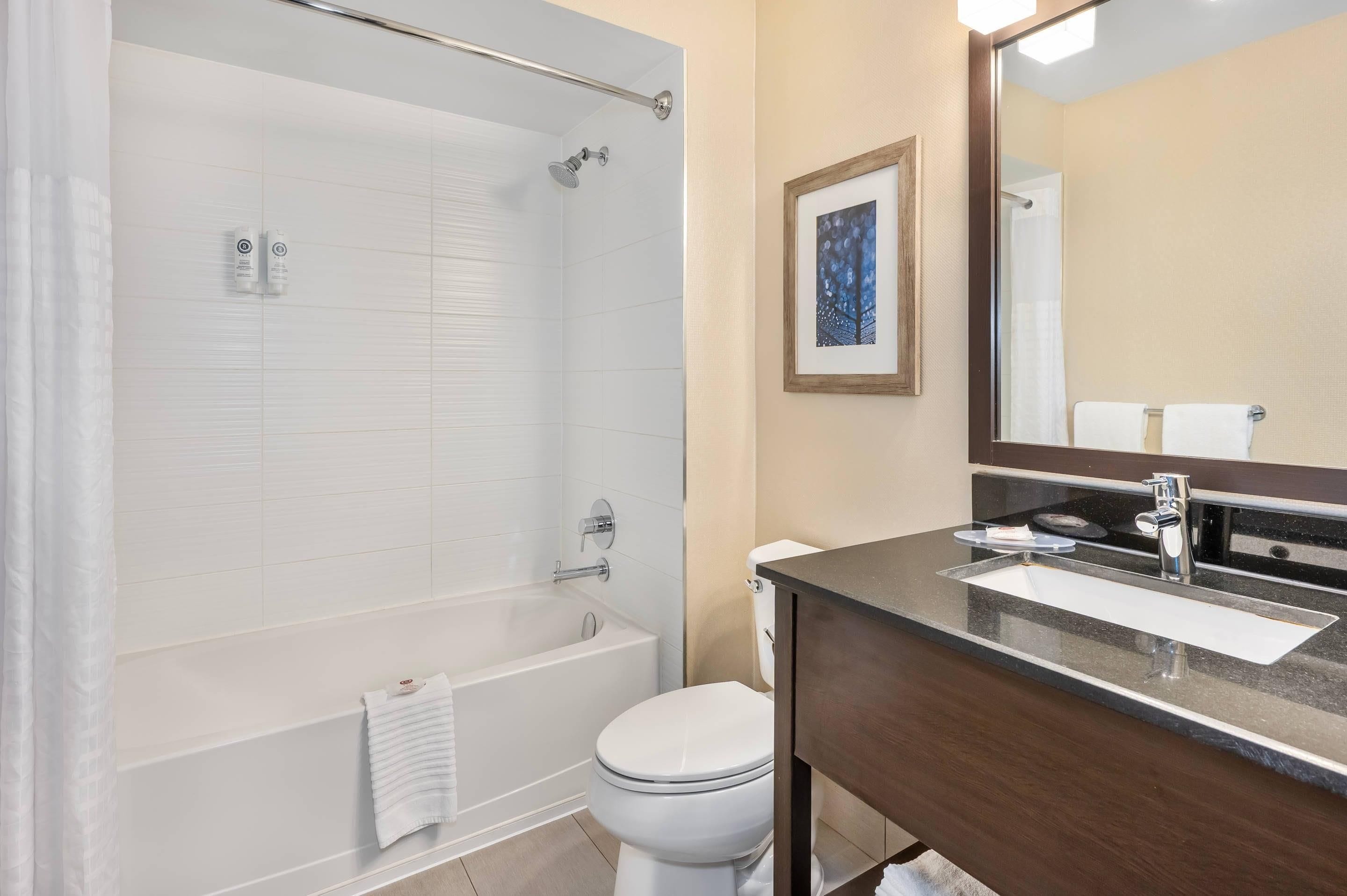 Un baño moderno con bañera, inodoro y lavamanos.