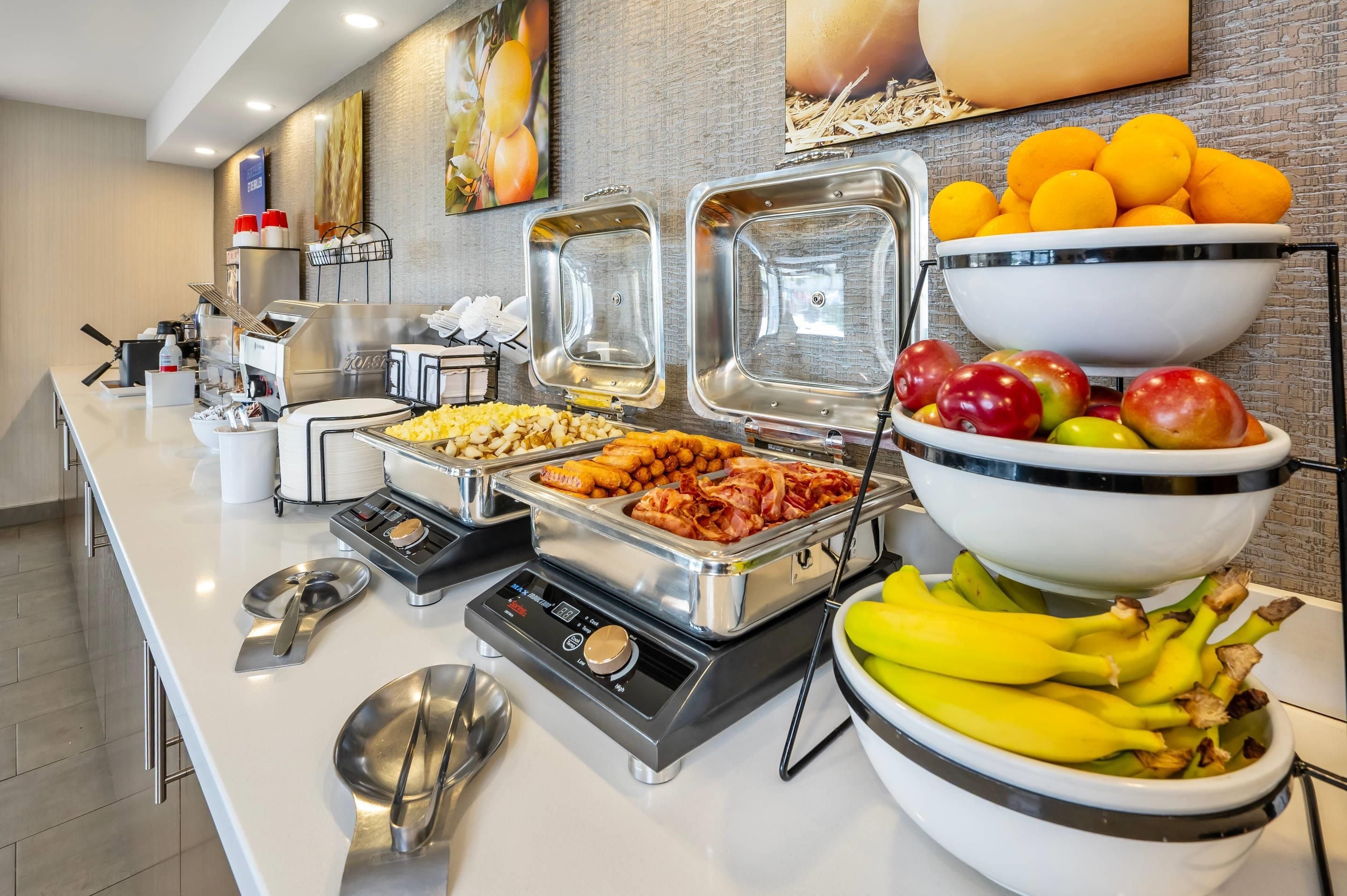 A buffet setup with various food items and a coffee station.