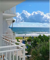 On the beach, white sand, sun loungers, beach umbrellas