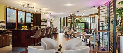 A modern interior with a bar area, seating, and a large window.