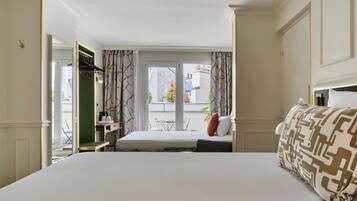 Een hotelkamer met een bed, een bureau en uitzicht.
