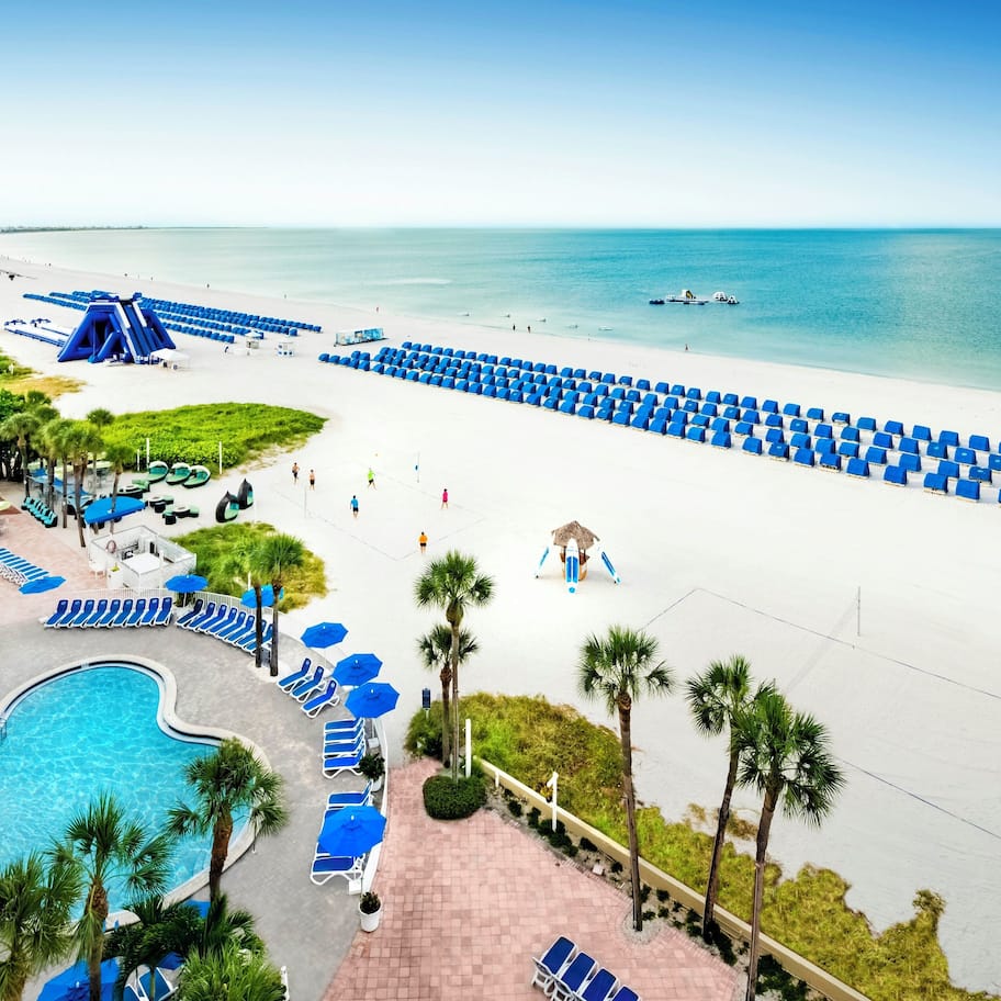On the beach, white sand, sun loungers, beach umbrellas