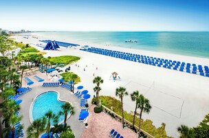 On the beach, white sand, sun loungers, beach umbrellas
