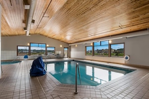 Una piscina techada, sillones reclinables de piscina
