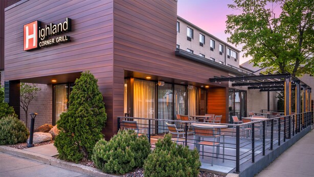 A modern building with a sign reading 'Highland Corner Grill.' - Best Western Plus InnTowner Madison (Madison)