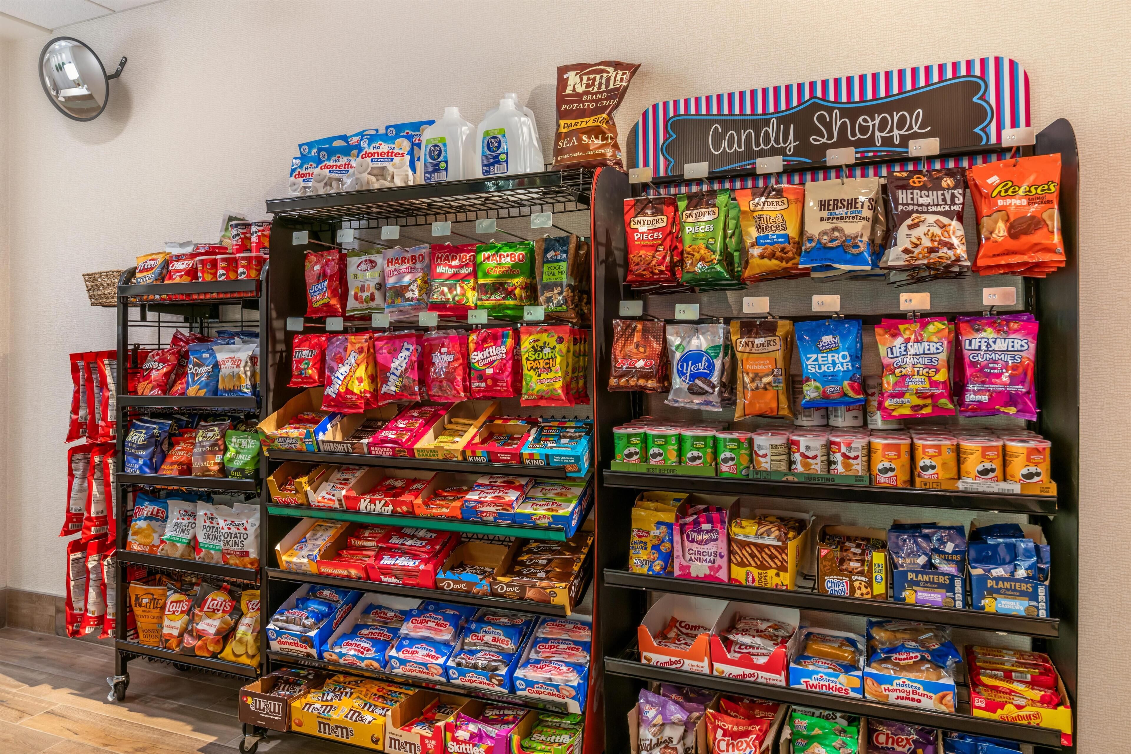 A candy store with shelves stocked with various snacks and a sign reading 'Candy Shoppe'.
