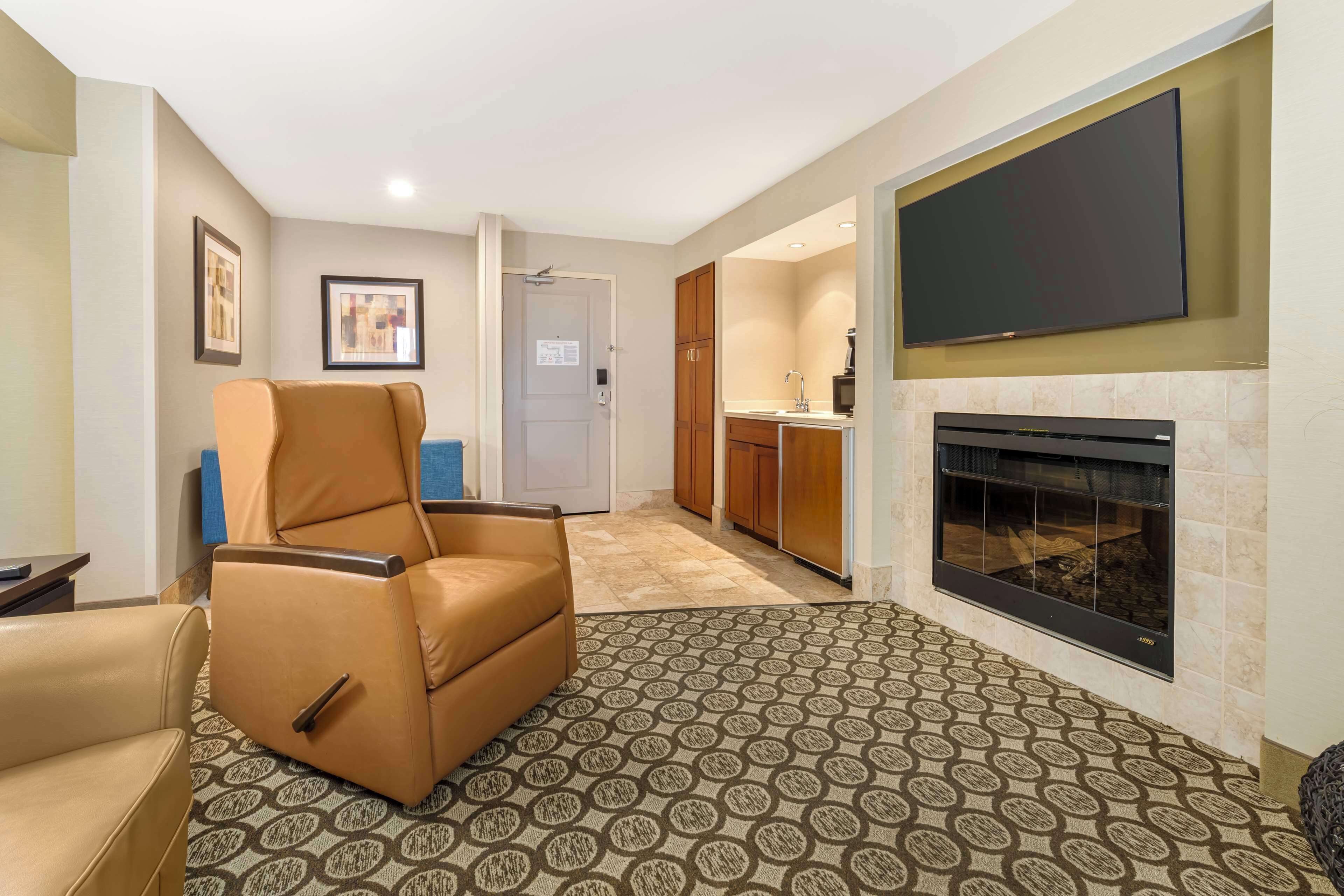 suite, 1 king bed, fireplace (separate living room) | 1 bedroom, desk, laptop workspace, iron/ironing board