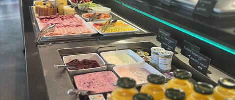A buffet with various food items and beverages.