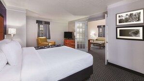 A hotel room with a large bed, a television, a desk, and a chair. - La Quinta Inn by Wyndham Midland (Midland)