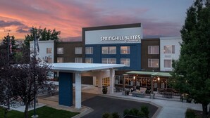 A hotel with a modern design, featuring a covered entrance and outdoor seating area. - SpringHill Suites by Marriott Boise ParkCenter (Boise)