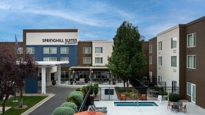A hotel with a pool, outdoor seating, and a covered patio area. - SpringHill Suites by Marriott Boise ParkCenter (Boise)