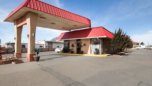 A gas station with a red roof and a single-story building.