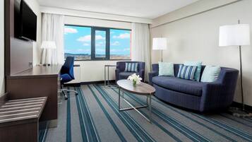 Suite, 1 King Bed with Sofa bed | Living area | 32-inch Smart TV with cable channels, TV, Netflix