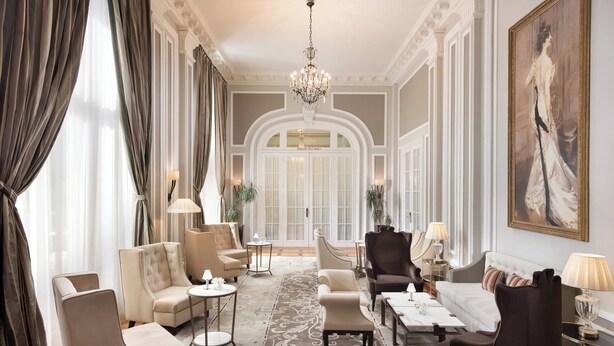 A luxurious hotel lobby with a grand chandelier, elegant seating, and a large portrait on the wall. - Hotel Maria Cristina, a Luxury Collection Hotel (San Sebastián)
