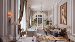A luxurious hotel lobby with a grand chandelier, elegant seating, and a large painting on the wall. - Hotel Maria Cristina, a Luxury Collection Hotel (San Sebastián)