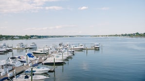 A marina with multiple boats docked at wooden piers.