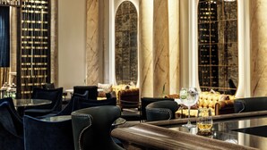 A luxurious interior with marble columns, plush seating, and a bar area. - Sofia Balkan Palace (Sofia)