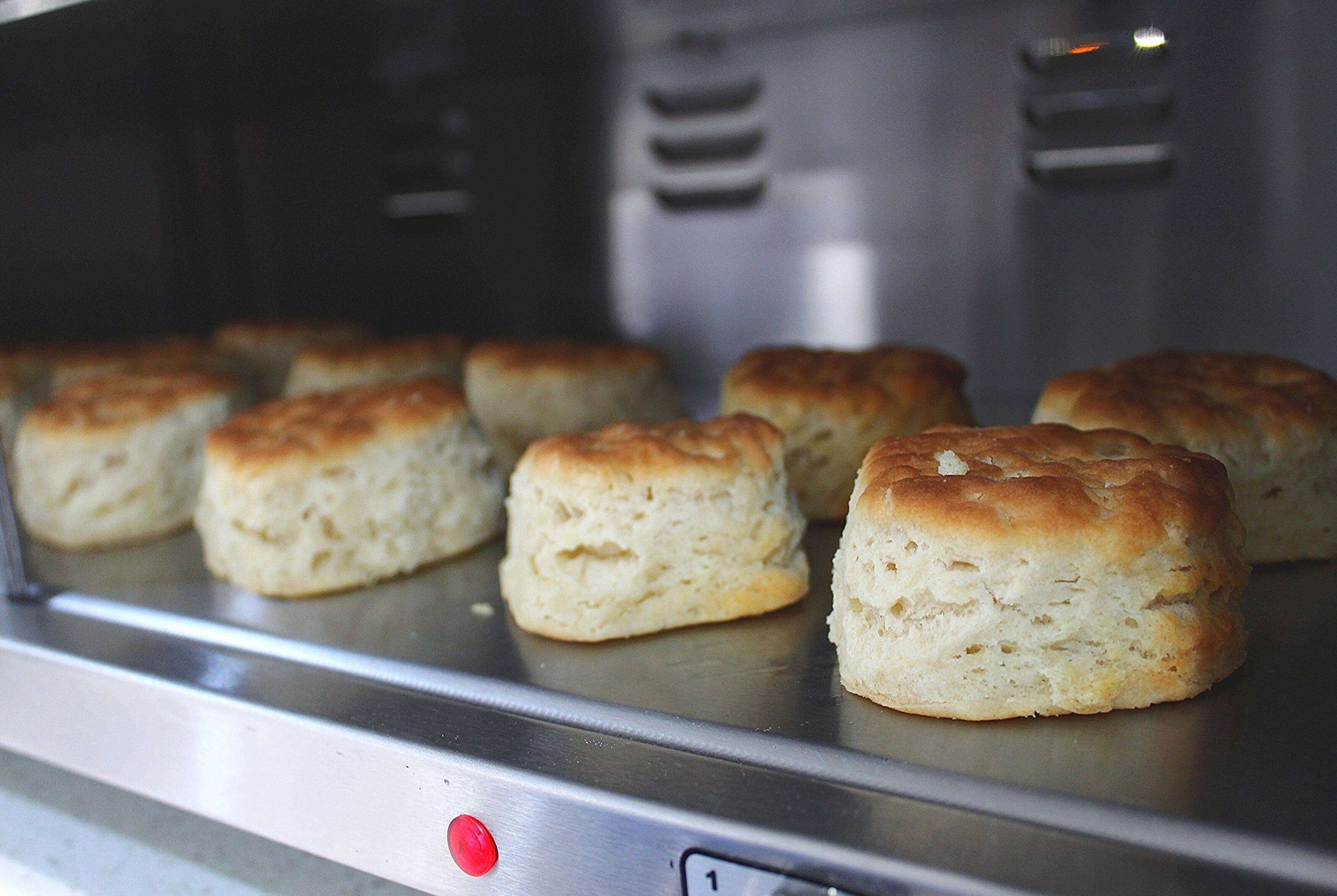 A stainless steel appliance with six baked goods on it.