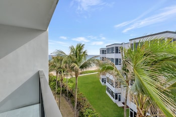 Hotel room view looking out at Tideline Palm Beach Ocean Resort and Spa