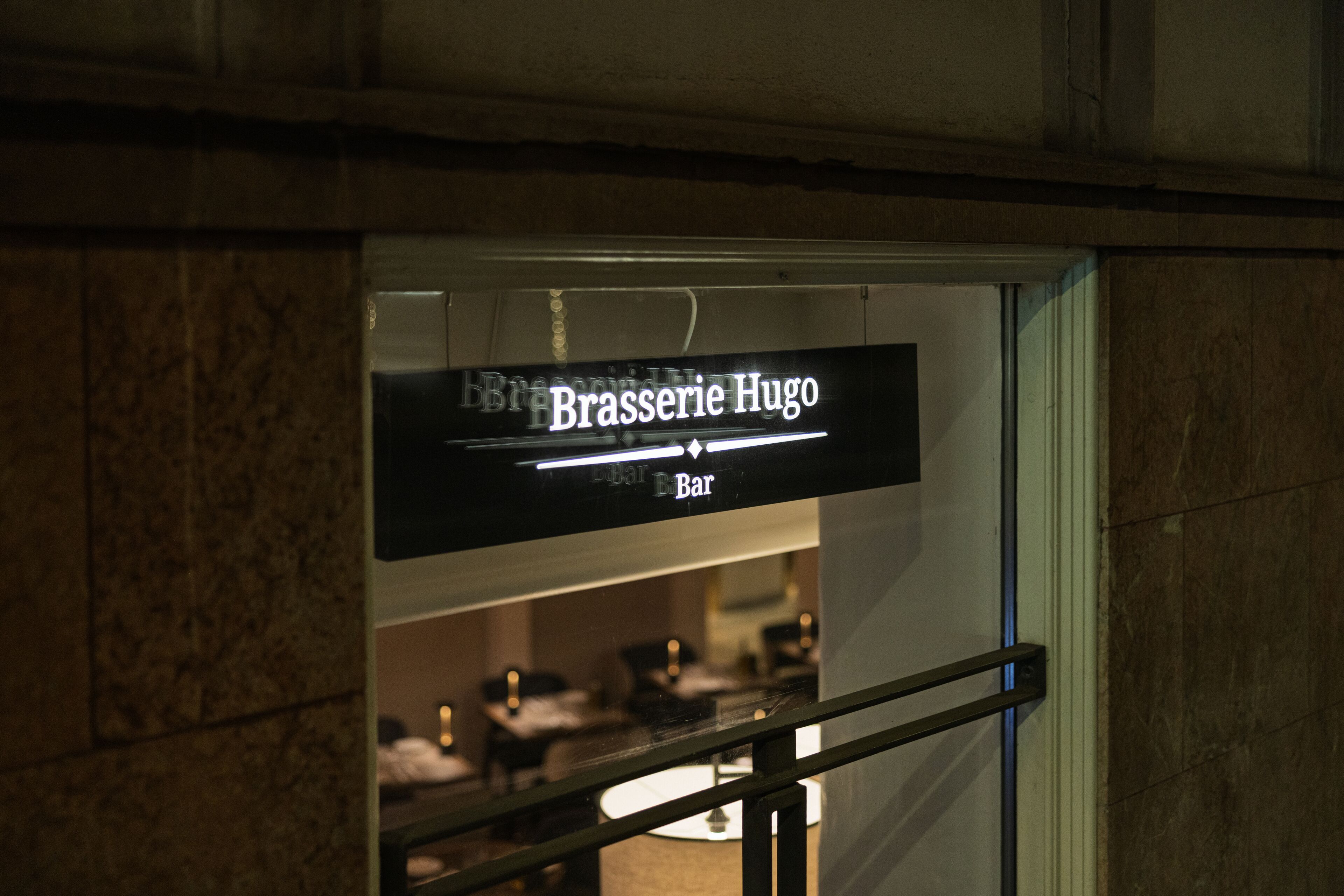 A sign for Brasserie Hugo Bar.