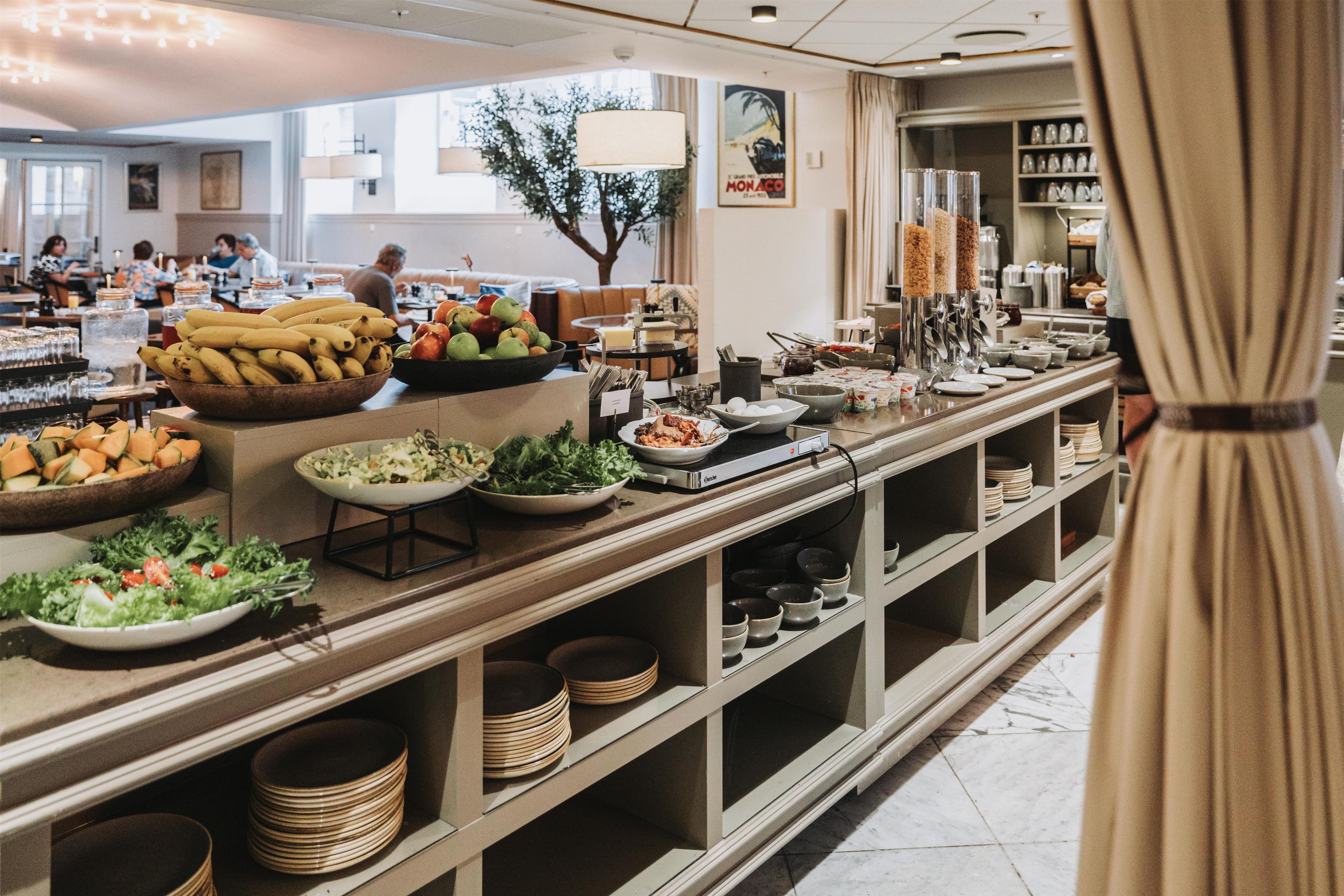 A buffet area with various food items and a salad bar.
