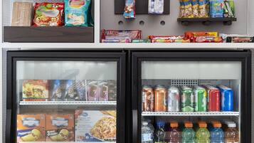 A comfort cart with snacks, beverages, and a refrigerator stocked with food and drinks.
