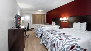 A hotel room with a bed, a desk, a television, and a lamp. - Red Roof Inn Chicago-O'Hare Airport/ Arlington Hts (Arlington Heights)