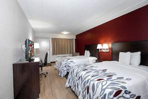 A hotel room with a bed, a desk, a television, and a lamp. - Red Roof Inn Chicago-O'Hare Airport/ Arlington Hts (Arlington Heights)