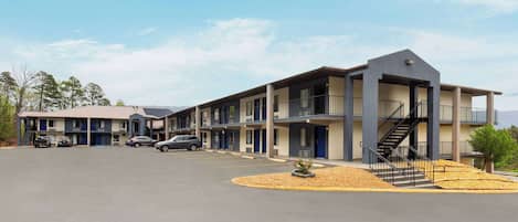 A motel with multiple units, a parking lot, and a central staircase.