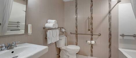 A modern bathroom with a sink, toilet, and shower.