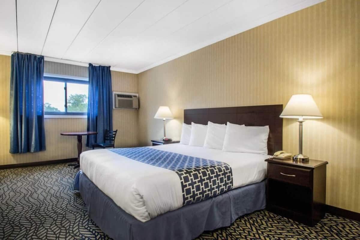 Desk, laptop workspace, blackout drapes, iron/ironing board