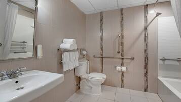A modern bathroom with a sink, toilet, and shower area.