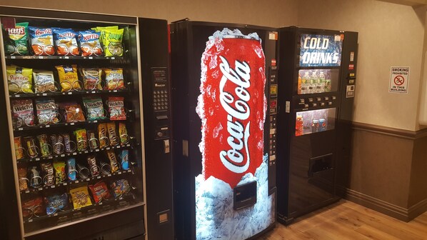 A vending machine area with snacks, a Coca-Cola machine, and a cold drinks machine.