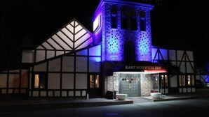 A building with a prominent tower and a sign reading "EAST NORWICH INN". - East Norwich Inn (East Norwich)