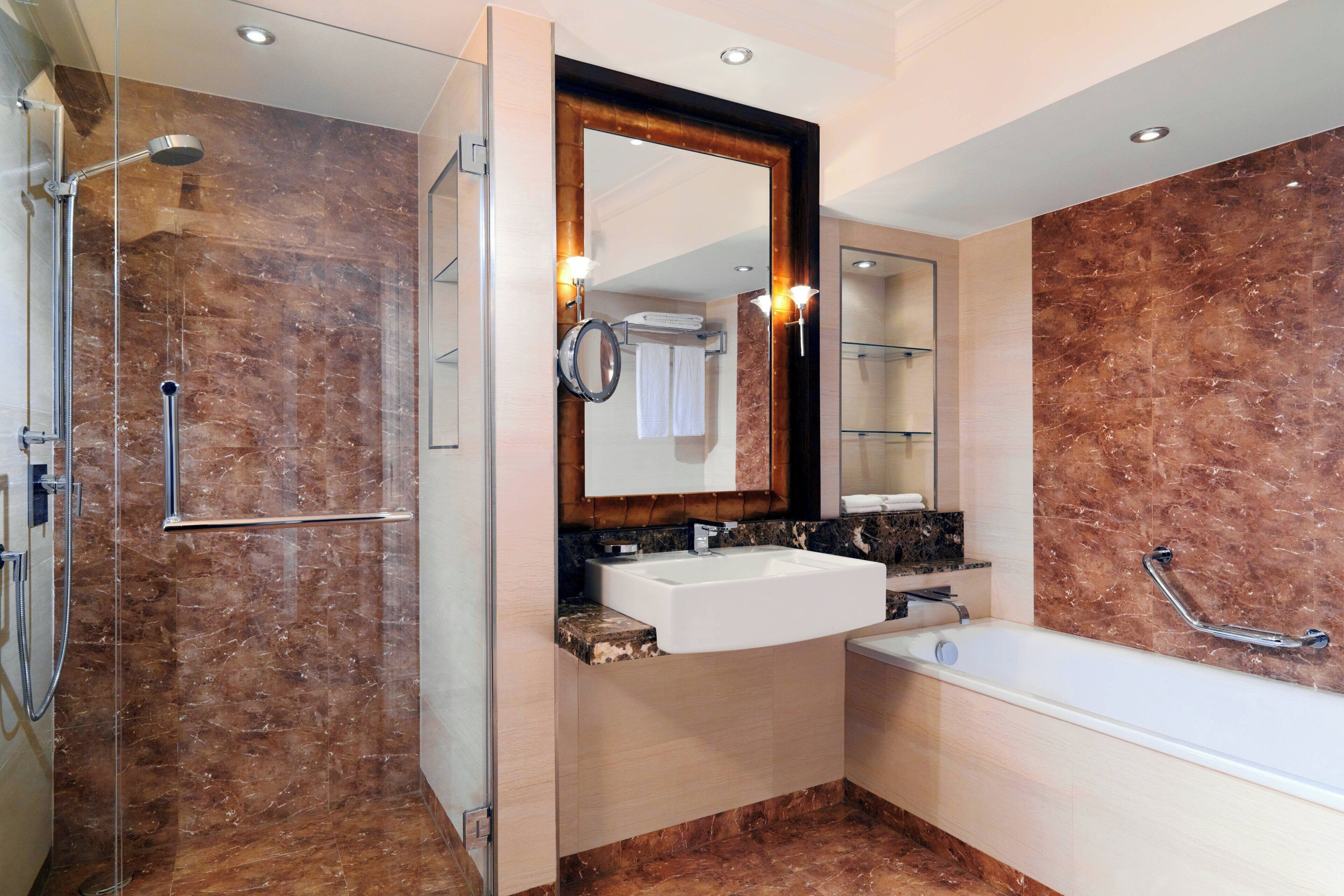 club suite, 1 king bed, non smoking, pool view (corner) | bathroom | free toiletries, hair dryer, bathrobes, slippers